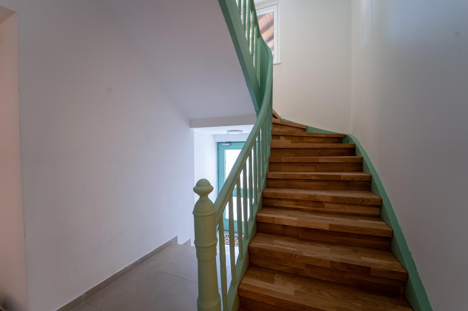 Neu verlegte Holztreppe mit farbigem Geländer